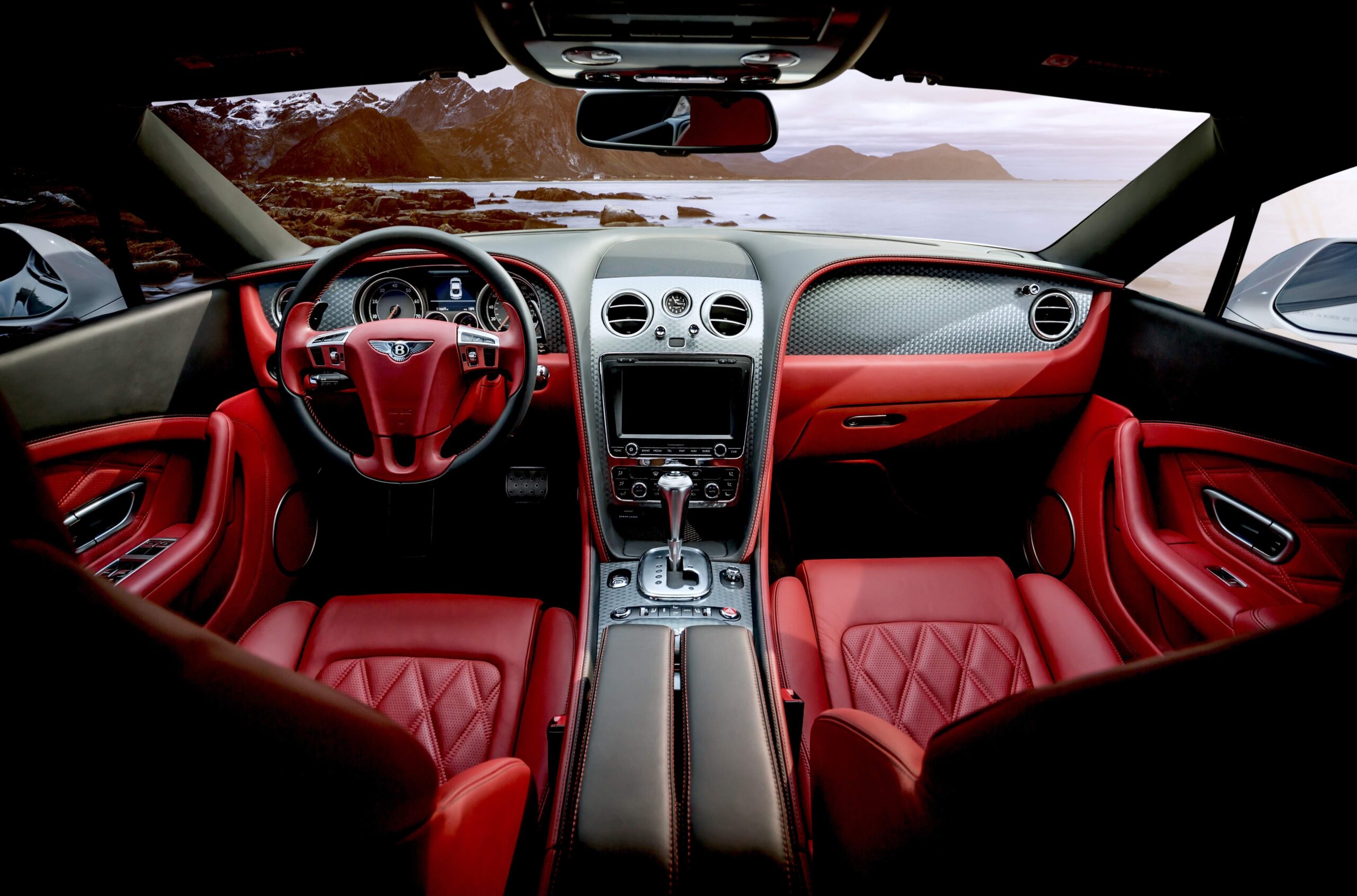 Luxury car interior with leather upholstery, wood and aluminum accents, advanced infotainment, ambient lighting