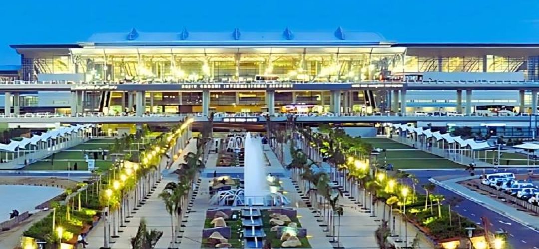 ProRido luxury chauffeur waiting at modern airport arrivals palm trees twilight